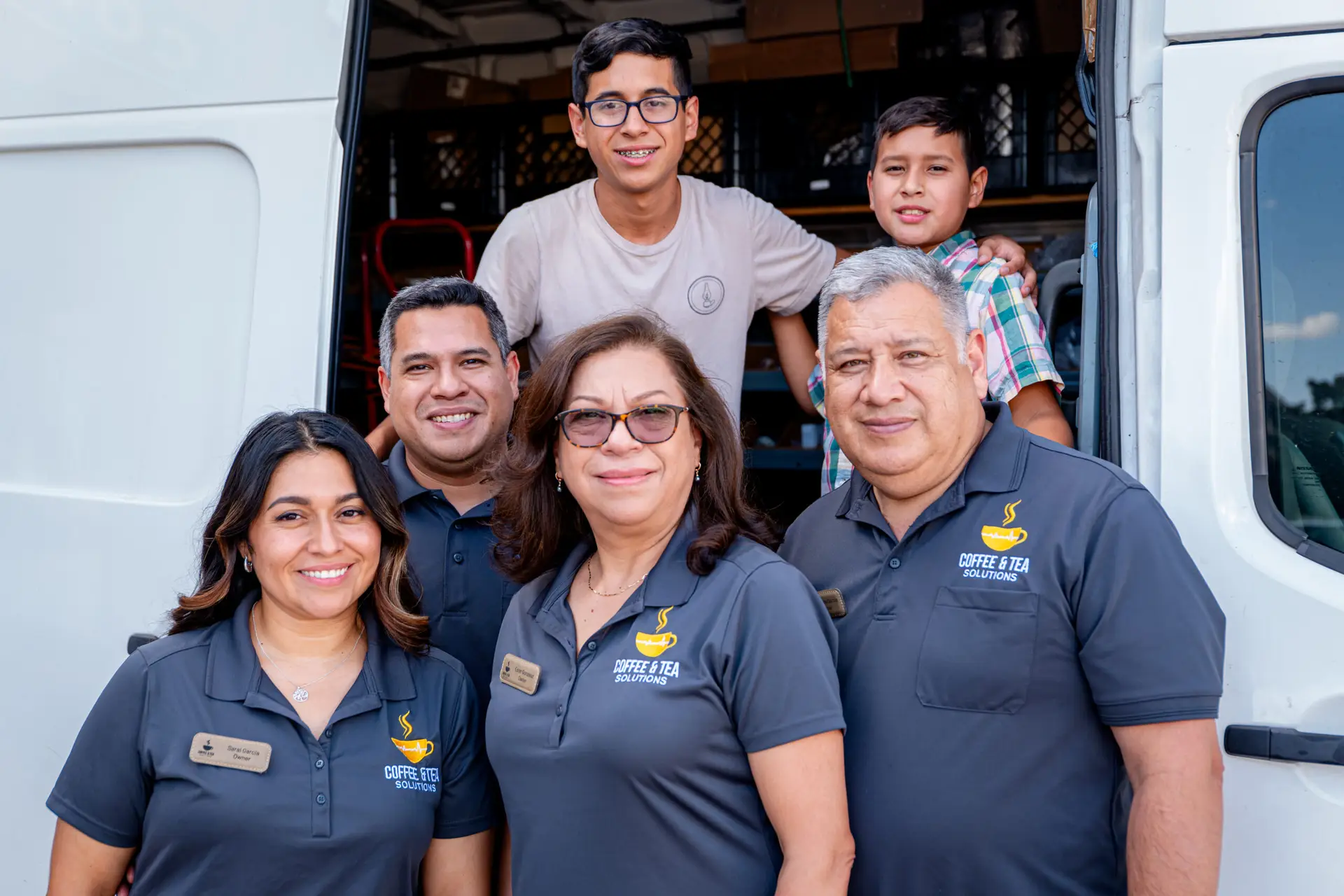 Coffee & Tea Solutions team standing in front of a company service van in Burleson, TX