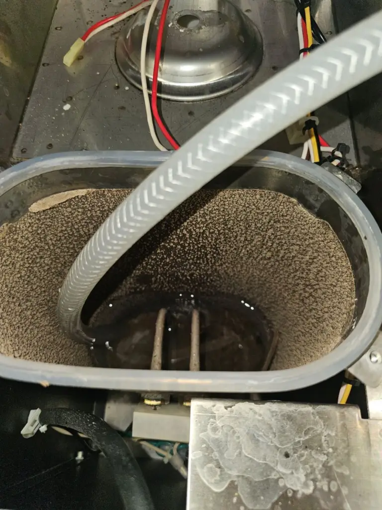 Mineral scale deposits inside a beverage equipment tank