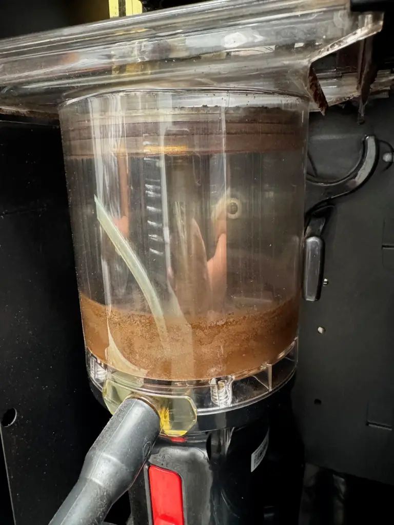 Coffee residue built up inside a clear chamber of a coffee machine