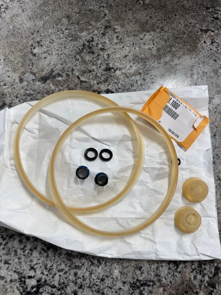 Worn faucet seals and gaskets removed during a preventive maintenance visit