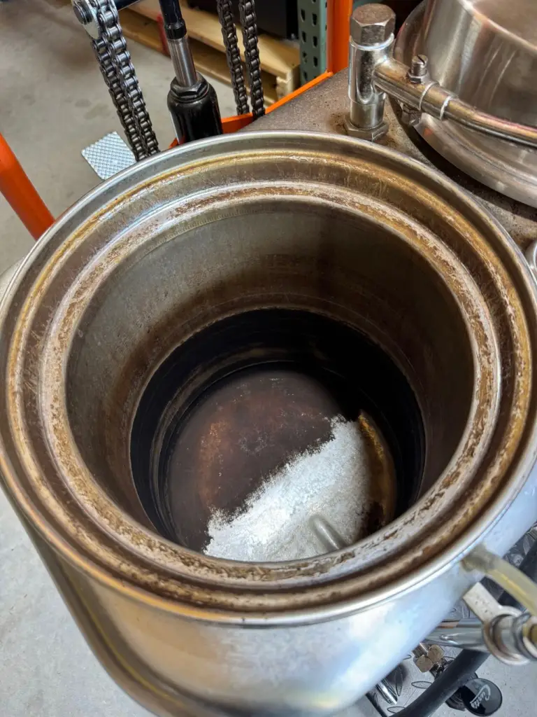 Coffee residue and buildup coating the inside of a coffee urn drum